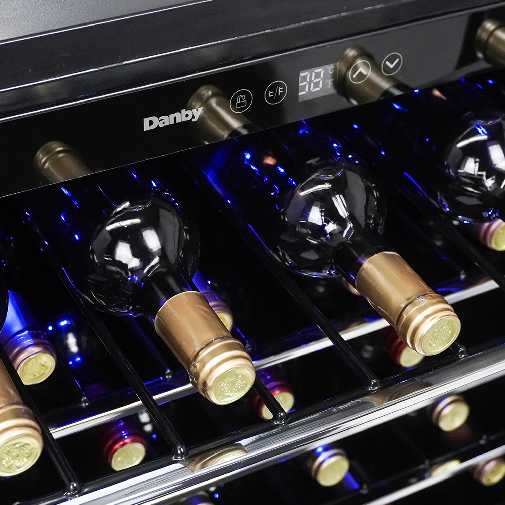 Danby appliances 60 bottle built in wine cooler stainless DWC057A1BSS close-up of interior shelves with wine bottles and blue LED lighting