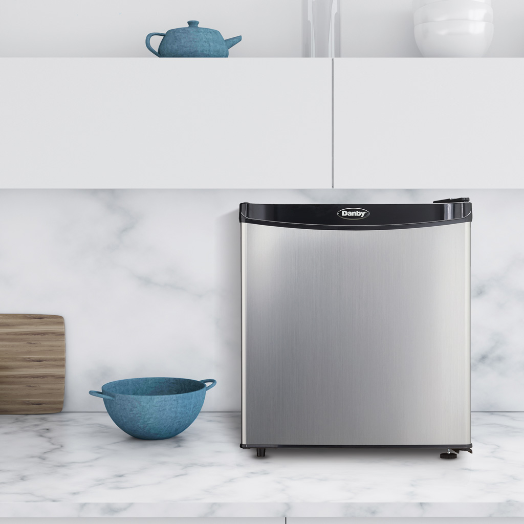 Danby 1.6 cu. ft. Compact Fridge in Stainless Steel Look 4 Danby appliances 1.6 cu ft compact fridge stainless DAR016A1BSS shown on a kitchen countertop beside dishes and décor, highlighting compact size and everyday use