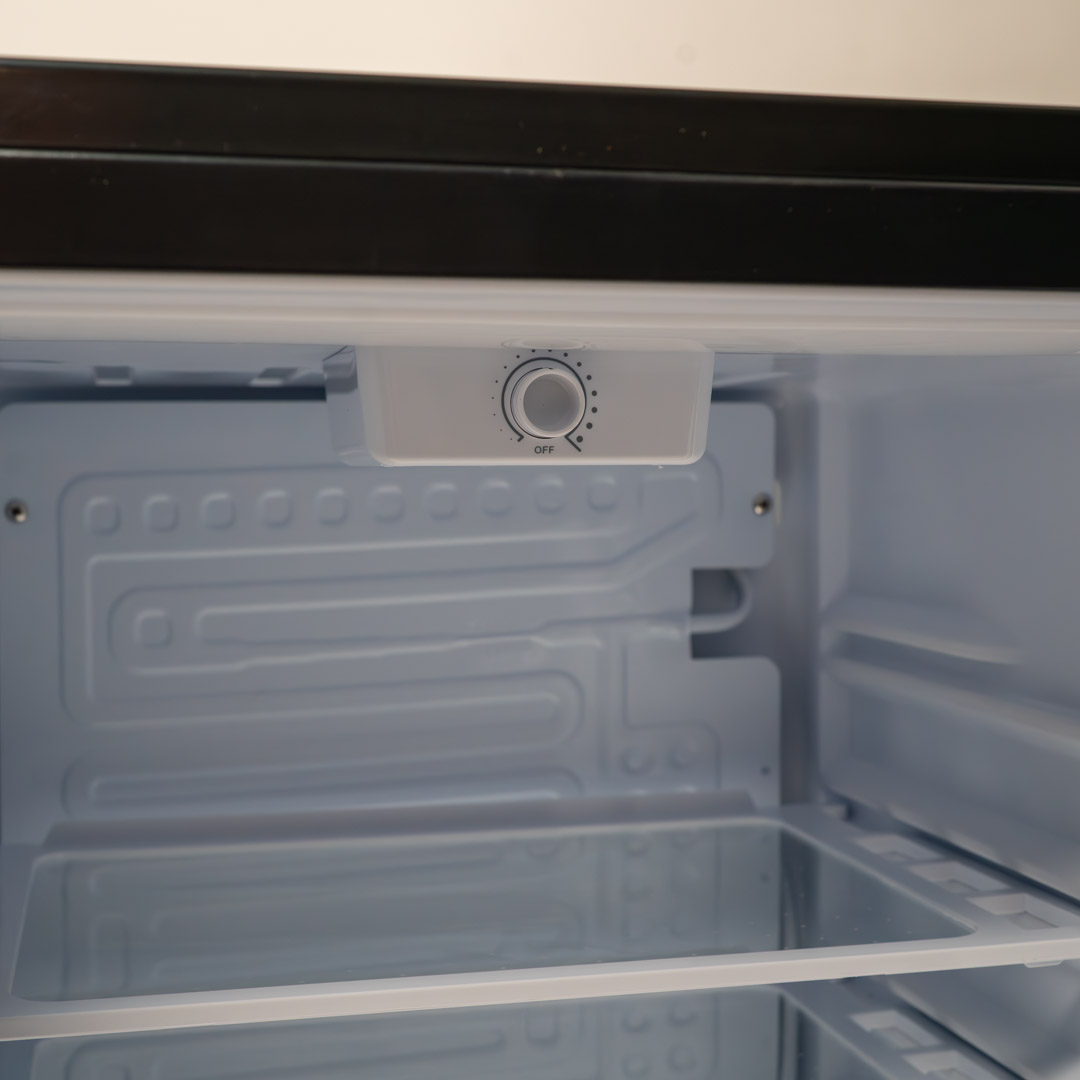 Danby appliances 2.6 cu ft compact fridge black DAR026A1BDD close-up of interior shelf or temperature control area showing compact layout inside the fridge