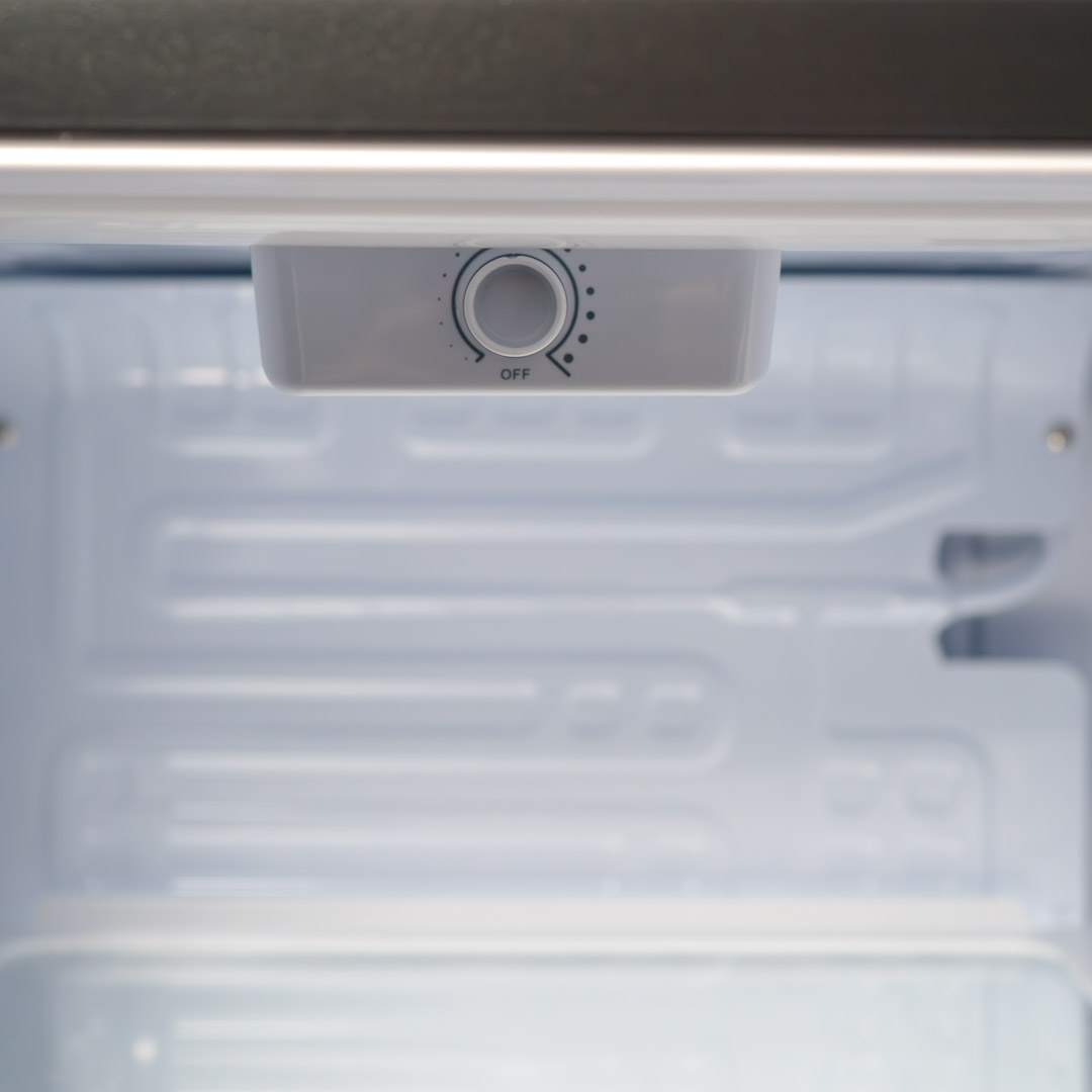 Danby appliances 3.3 cu ft compact fridge black DAR033A1BDD close-up of interior temperature control dial located under the top panel