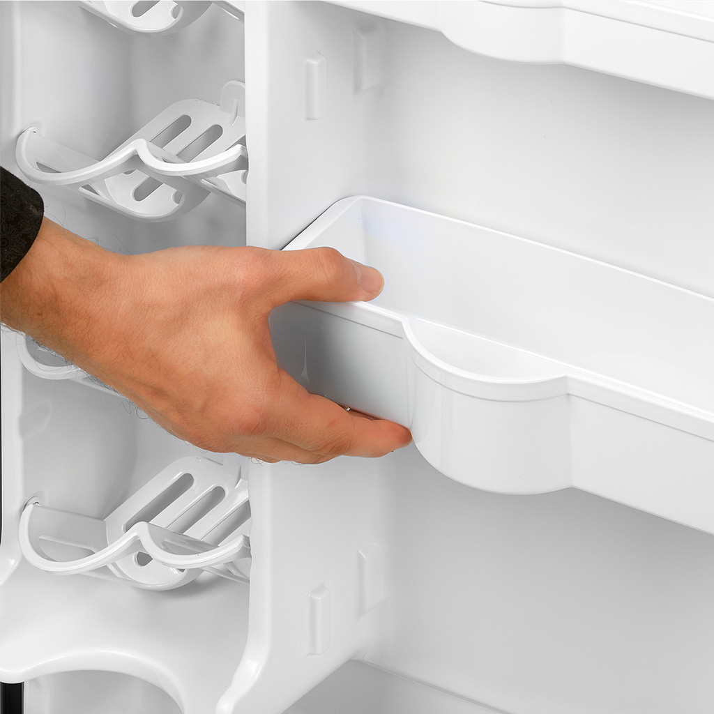 Danby appliances 4.4 cu ft compact fridge stainless DAR044A4BSLDD close-up of door storage bin being adjusted by hand showing interior door shelving