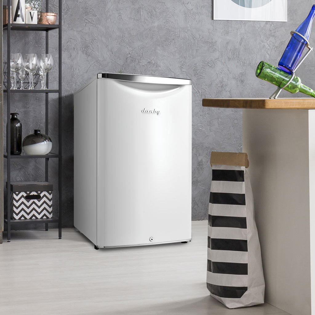 Danby 4.4 cu. ft. Contemporary Classic Compact Fridge in Pearl White 3 Danby appliances 4.4 cu ft compact fridge white DAR044A6PDB shown in a kitchen corner beside cabinets and countertop highlighting compact placement and everyday use