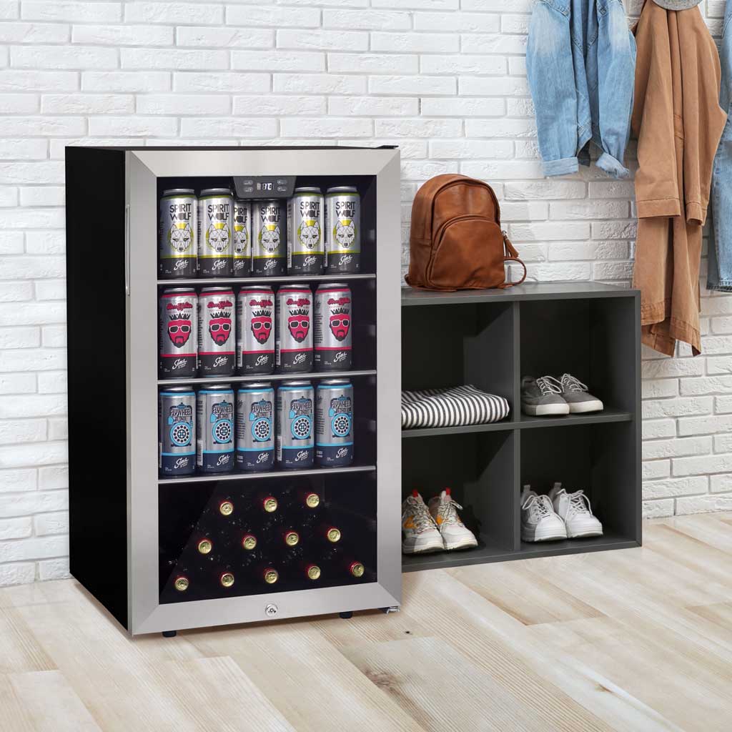 Danby appliances 4.5 cu ft beverage center stainless DBC045L1SS shown in a home entryway beside shelving with shoes and a backpack, displaying interior shelves stocked with beverage cans and bottles