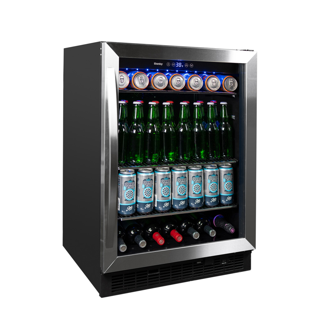 Danby appliances 5.7 cu ft built in beverage center stainless DBC057A1BSS angled front view showing glass door, stainless steel frame, digital control panel, and interior shelves stocked with beverage cans, glass bottles, and wine bottles on a plain background