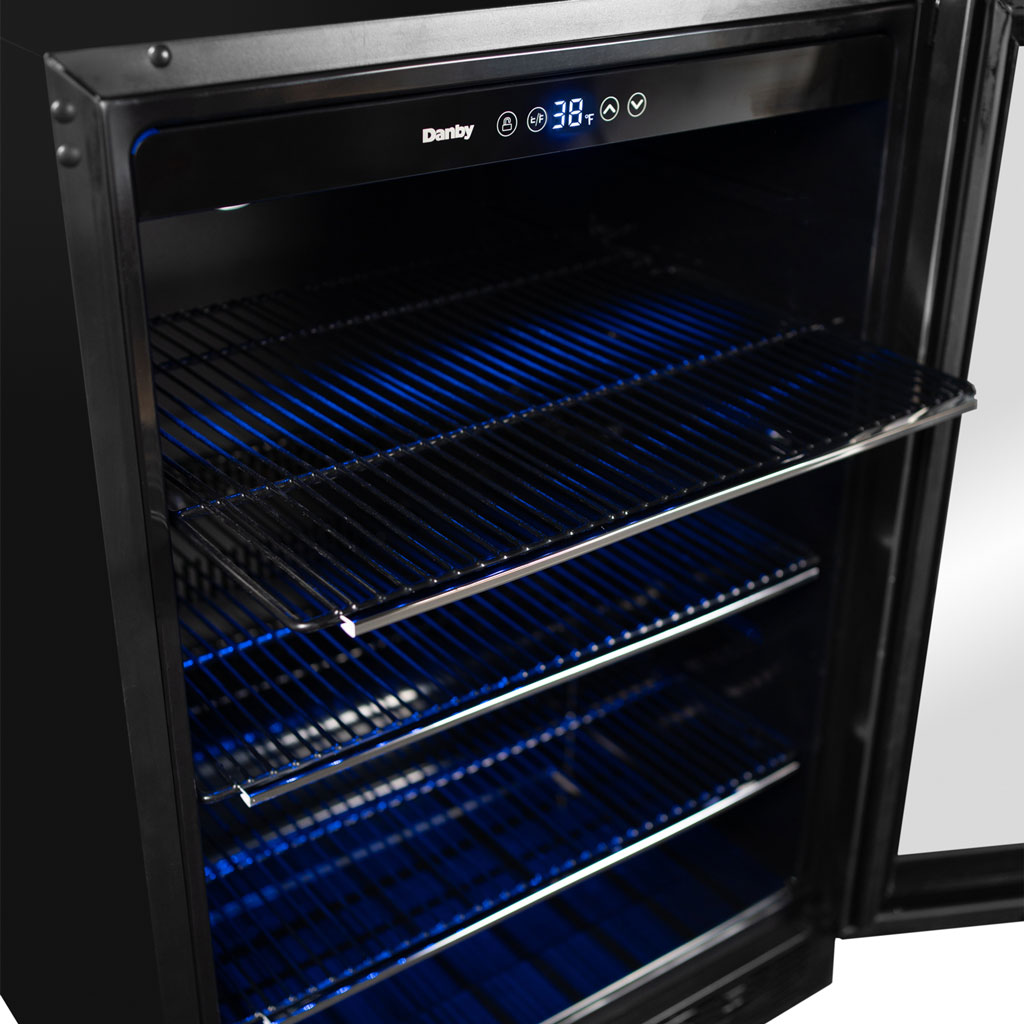 Danby appliances 5.7 cu ft built in beverage center stainless DBC057A1BSS close-up of interior wire shelf with blue LED lighting and metal rack detail