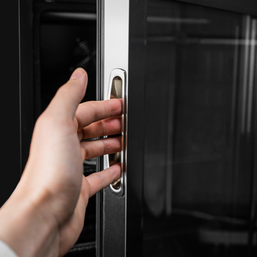 Danby appliances 3.1 cu ft beverage center stainless DBC117A1BSSDB-6 close-up of recessed door handle with hand opening the glass door