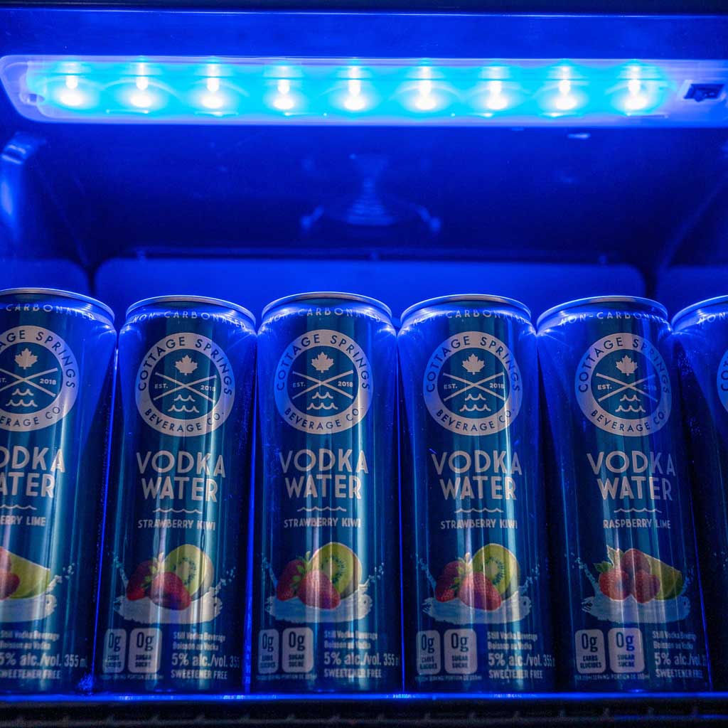 Danby 3.1 cu. ft. Free-Standing Beverage Center in Stainless Steel 10 Danby appliances 3.1 cu ft beverage center stainless DBC117A2BSSDD-6 close-up of beverage cans on shelf illuminated by blue LED lighting