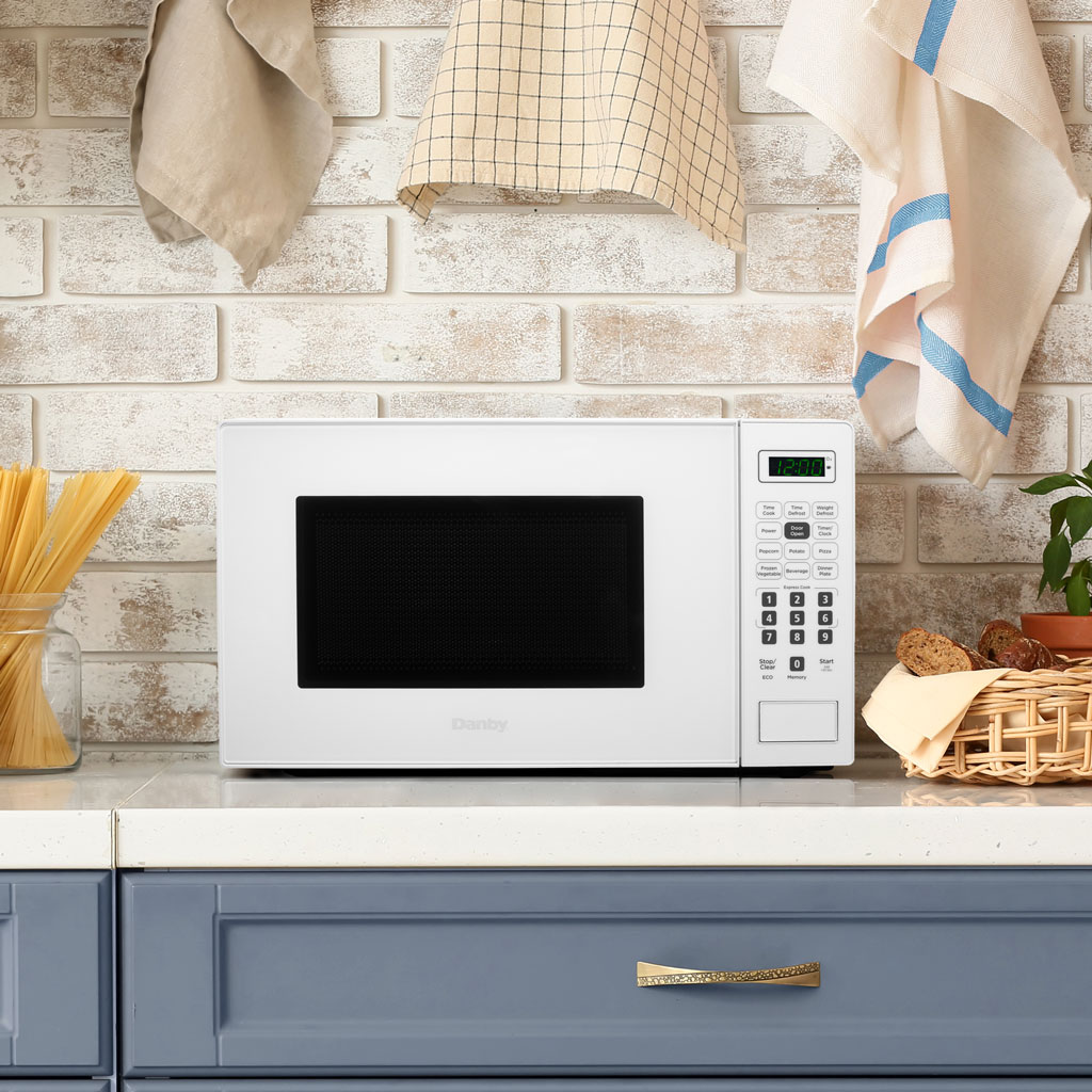Micro-ondes de comptoir Danby de 0,7 pi. cu. blanc 4 Micro-ondes Danby DBMW0721BWW de 0,7 pi³ sur comptoir, finition blanche, placé sur un comptoir dans une cuisine