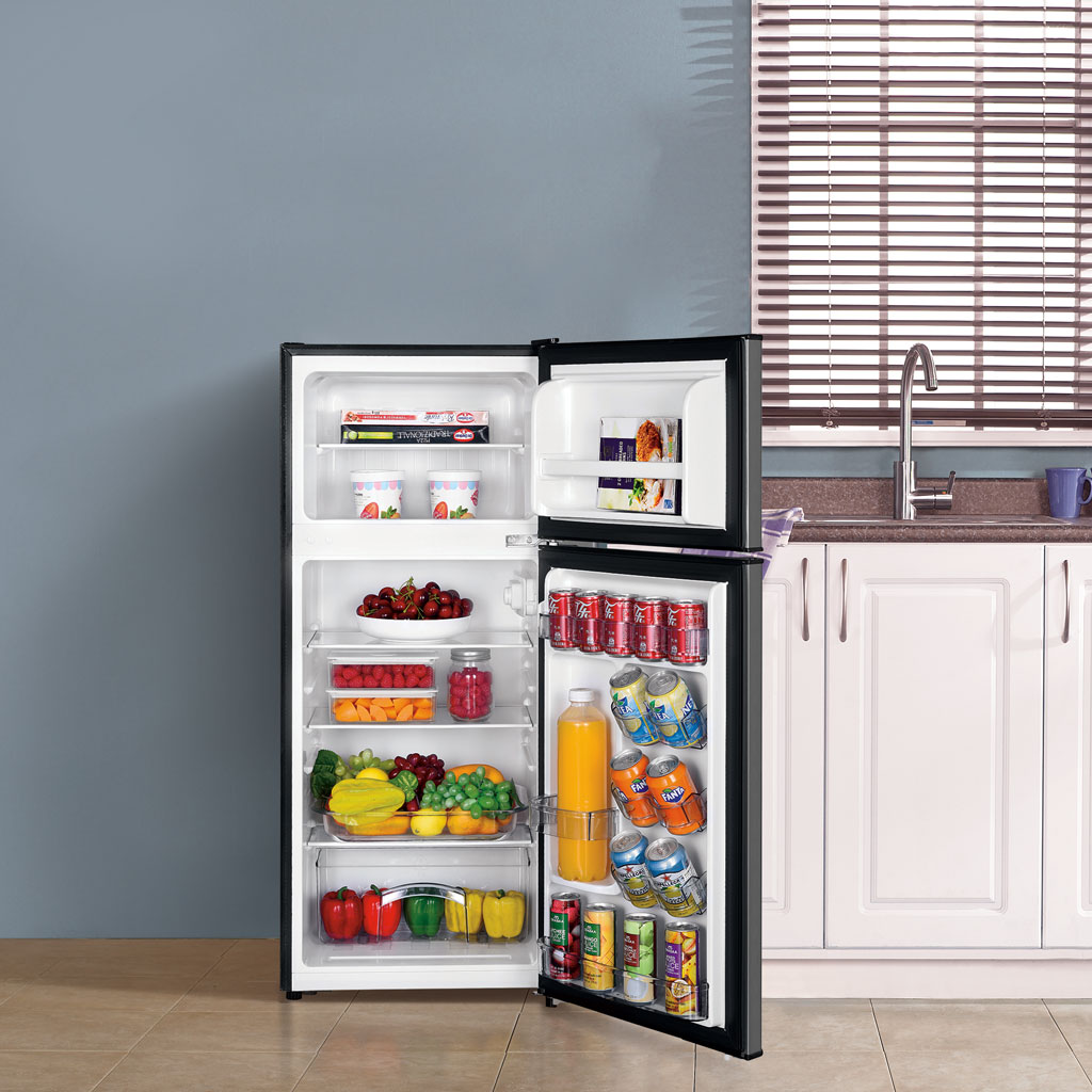 Danby appliances 4.5 cu ft compact fridge stainless DCR045B1SLDB 2 door open front view showing interior stocked with beverages, fruit, and food items beside kitchen cabinetry