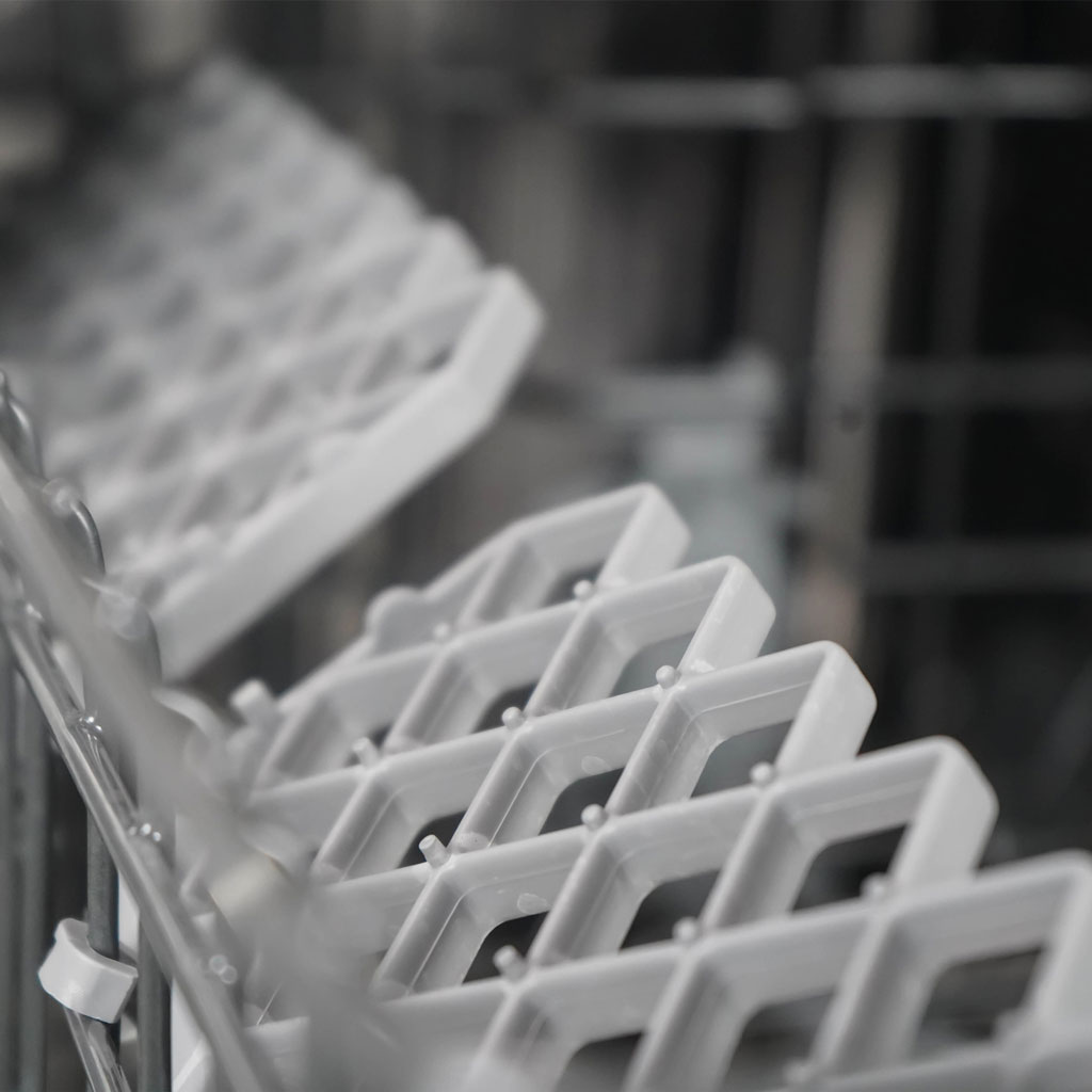 Danby appliances 18 inch built in dishwasher black DDW18D1EB lower rack grid with plate slots shown in a close-up view