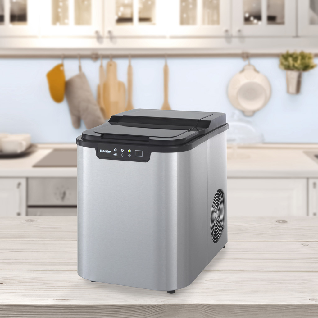 Danby DIM2500SSDB 25 lbs ice maker on kitchen countertop with everyday kitchen accessories