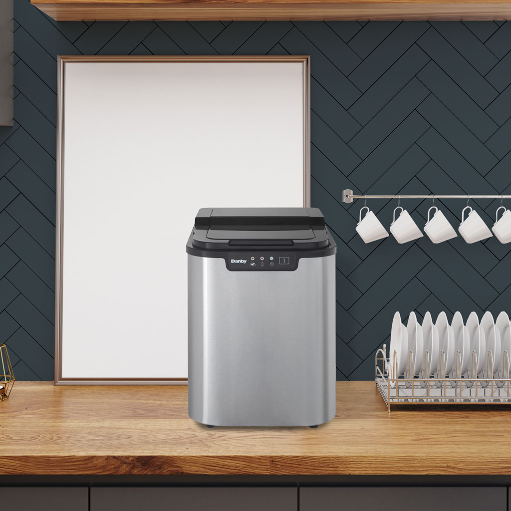Danby DIM2500SSDB 25 lbs ice maker on kitchen countertop in modern kitchen setting
