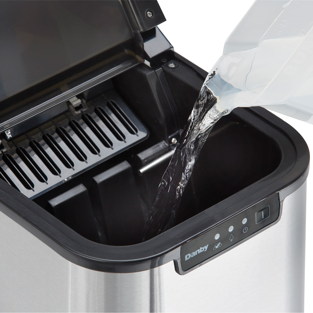 Danby DIM2500SSDB 25 lbs ice maker with water being poured into reservoir