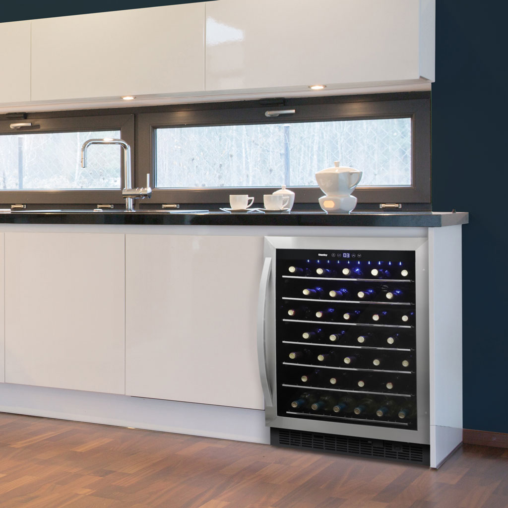 Danby appliances 60 bottle built in wine cooler stainless DWC057A1BSS installed in a kitchen island with white cabinetry and wood flooring, showing interior shelves stocked with wine bottles