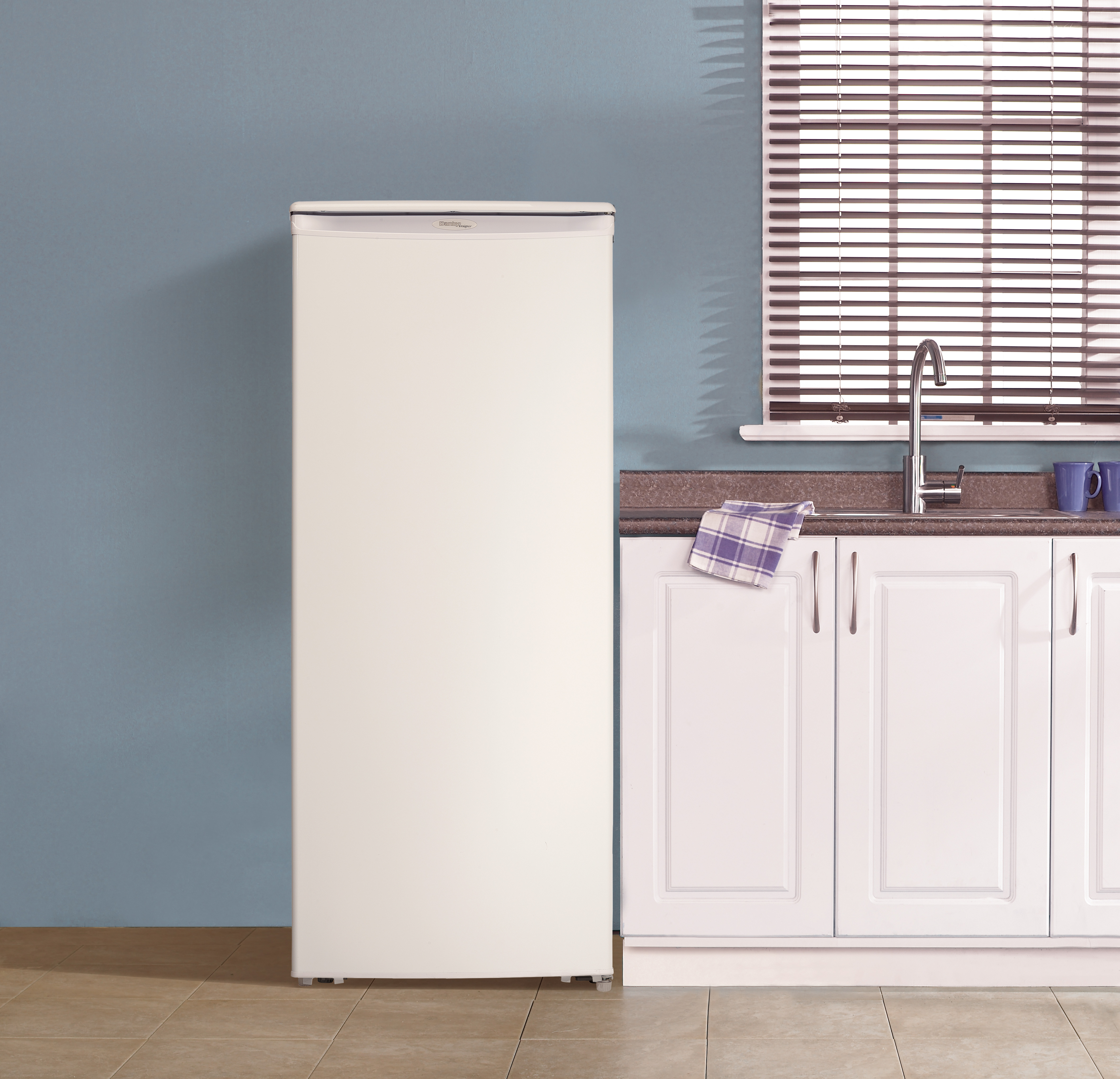 Danby Designer 10.1 cu. ft. Upright Freezer in White 4 Danby DUFM085A4WDD 8.5 cu ft upright freezer in utility space with organized frozen food storage