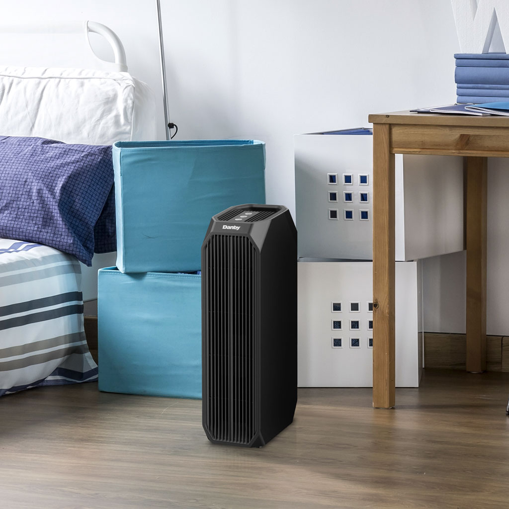Danby DAP143BAB-UV air purifier in bedroom setting beside bed providing air purification