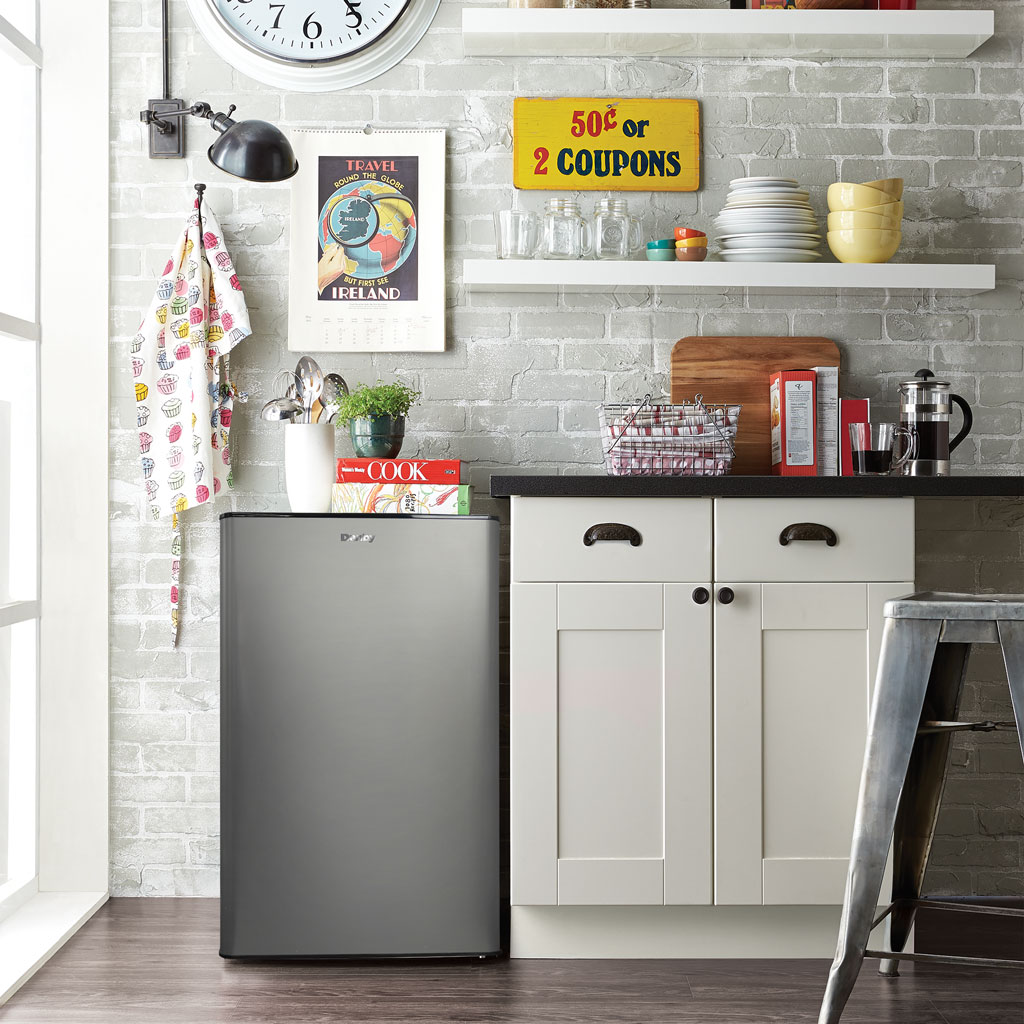 Danby DAR044A9SLDB 4.4 cu ft compact refrigerator in kitchen setting with food and beverage storage