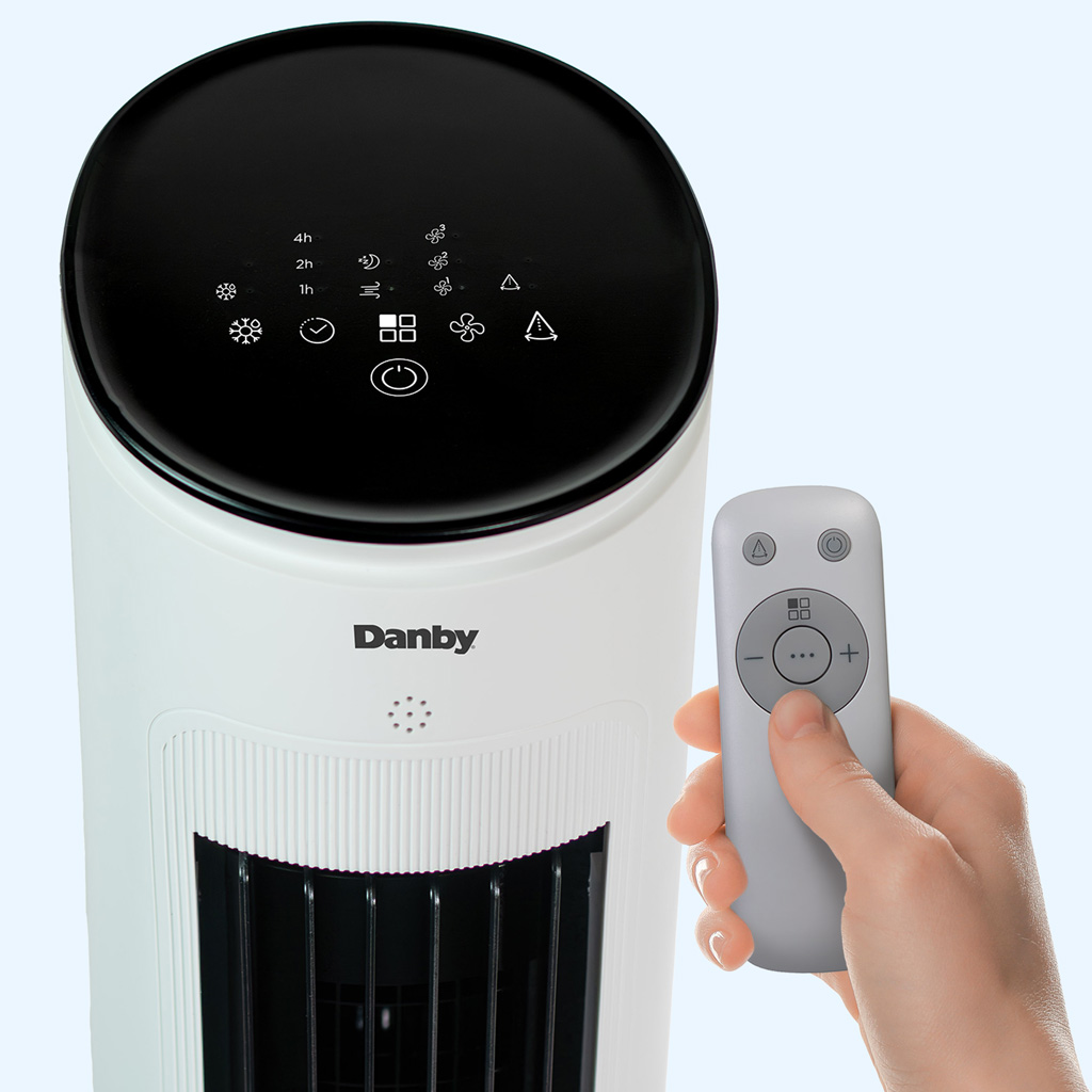 Danby DBEC42A41W 42 inch evaporative cooler top control panel with touch icons and remote control in hand