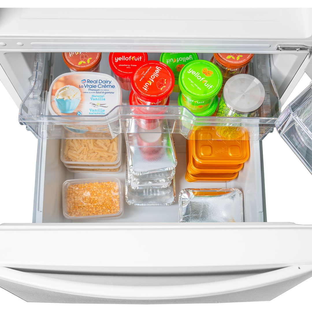Danby DBM187E1WDB 18.7 cu ft apartment fridge freezer drawer displaying frozen food storage