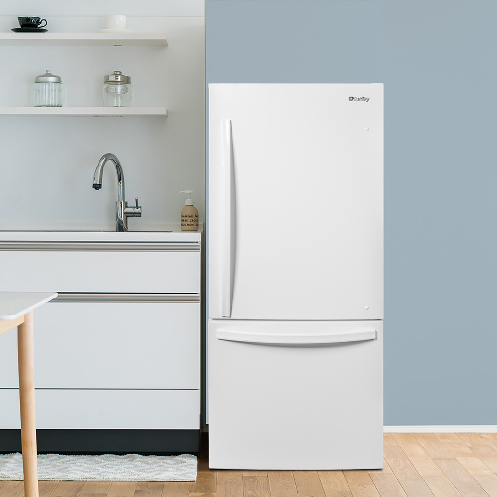 Danby DBM187E1WDB 18.7 cu ft apartment fridge in modern kitchen setting with white finish