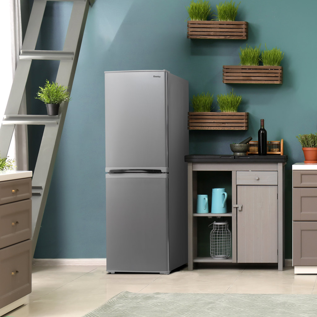 19 Inch 4.9 cu. ft. Bottom Mount Mini Refrigerator 5 Danby DCR049B1BSLDB 4.9 cu ft mini fridge in kitchen corner beside shelving and cabinet