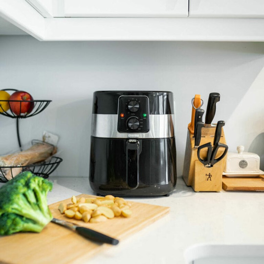 Air fryer cleaning guide featuring a Danby air fryer on a kitchen countertop with fresh ingredients