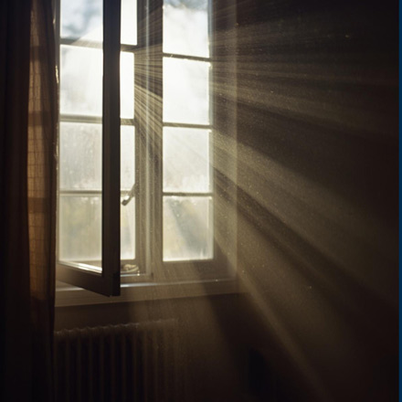 Sunlight and natural airflow through open window showing why your home feels stuffy during seasonal changes