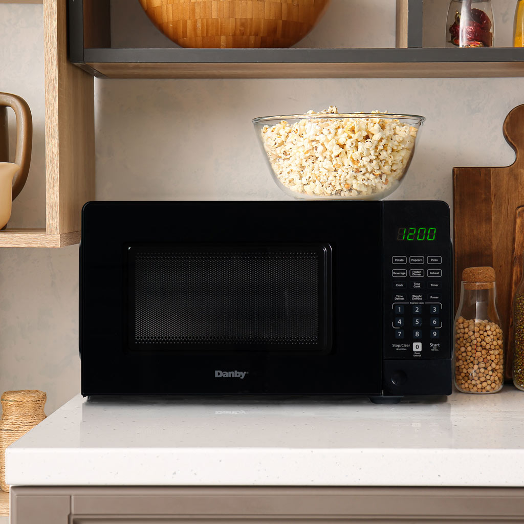 0.7 cu. ft. Countertop Microwave – 700 W 6 Danby DMW071A1B 0.7 cu ft countertop microwave heating food in kitchen setting