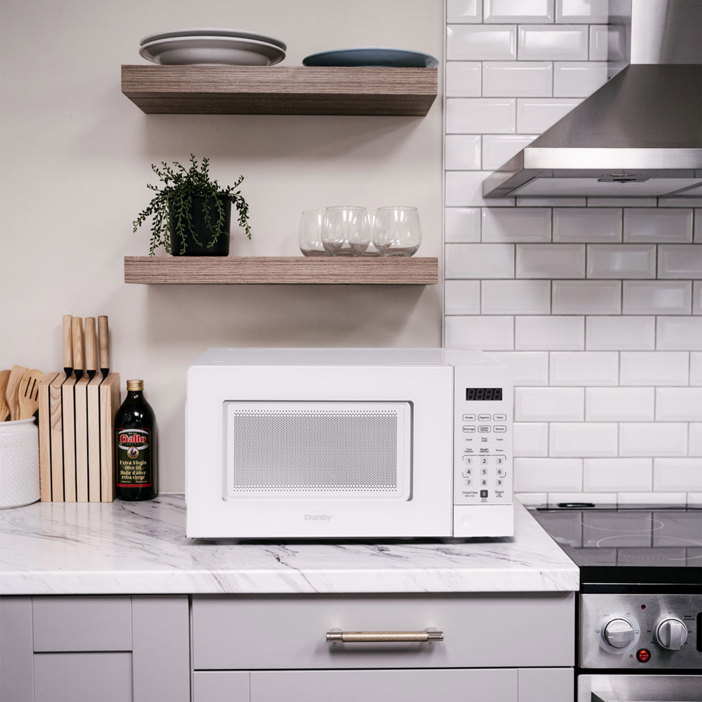 0.7 cu. ft. Countertop Microwave – 700 W 5 Danby DMW071A1W 0.7 cu ft countertop microwave on kitchen countertop in a modern kitchen setting