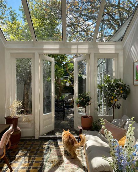 Bright sunroom with open windows and natural airflow illustrating why a home feels different during allergy season