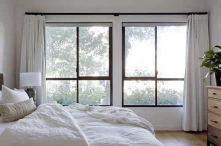 Bedroom with open windows and natural airflow illustrating why does my home feel stuffy during seasonal changes