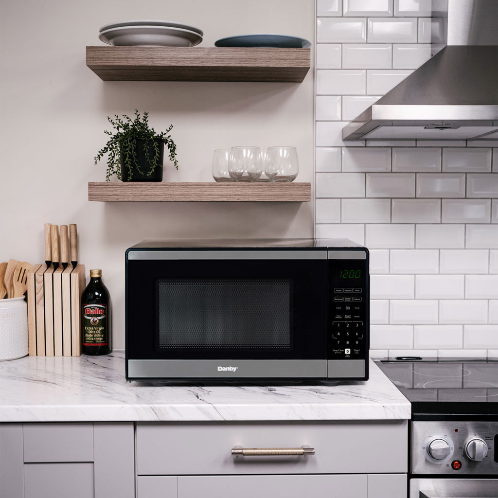 Danby DMW091A1SS 0.9 cu ft countertop microwave in kitchen setting on countertop