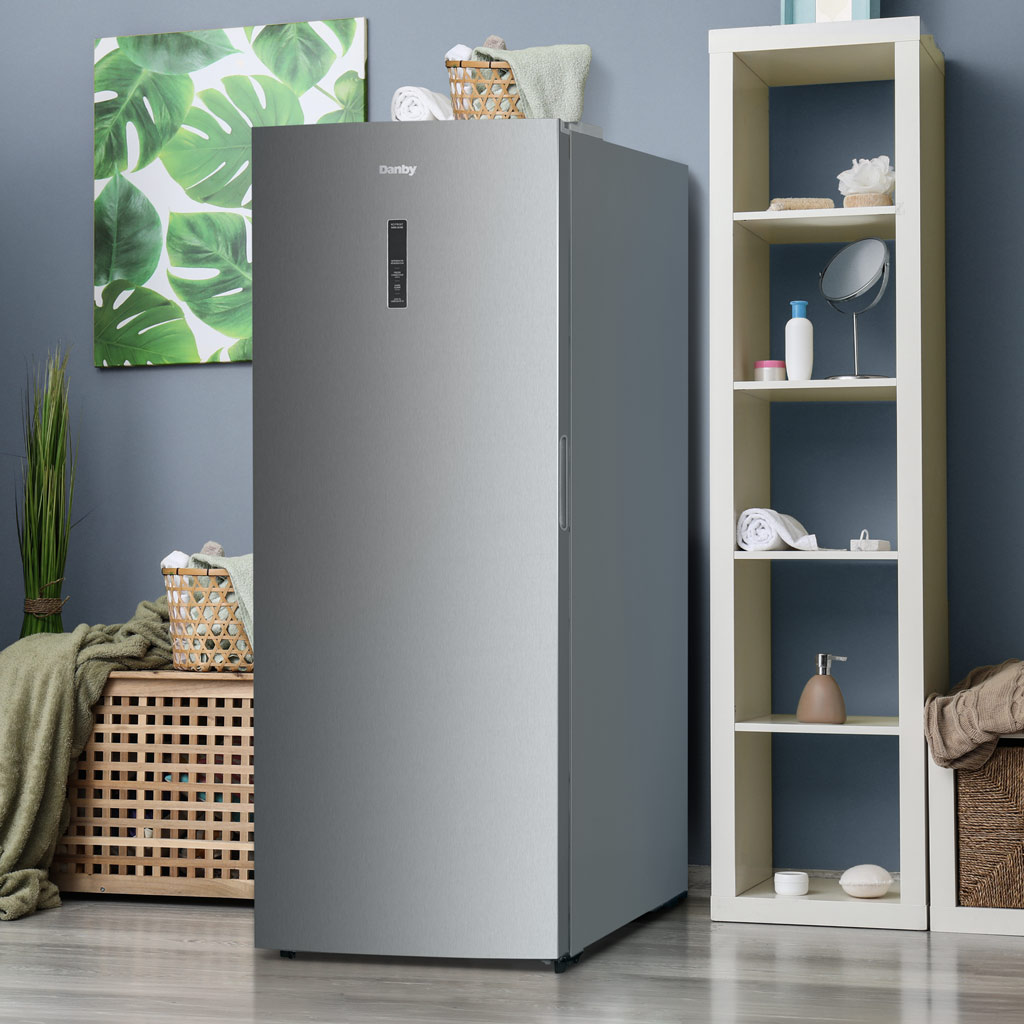Danby DUF212B1SLCDB 21.2 cu ft upright freezer in utility space with organized frozen food storage